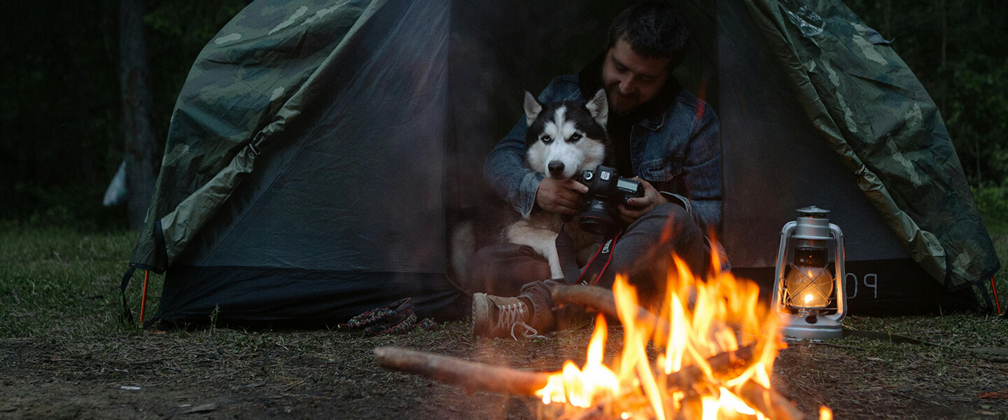 A dog and owner in a tent
