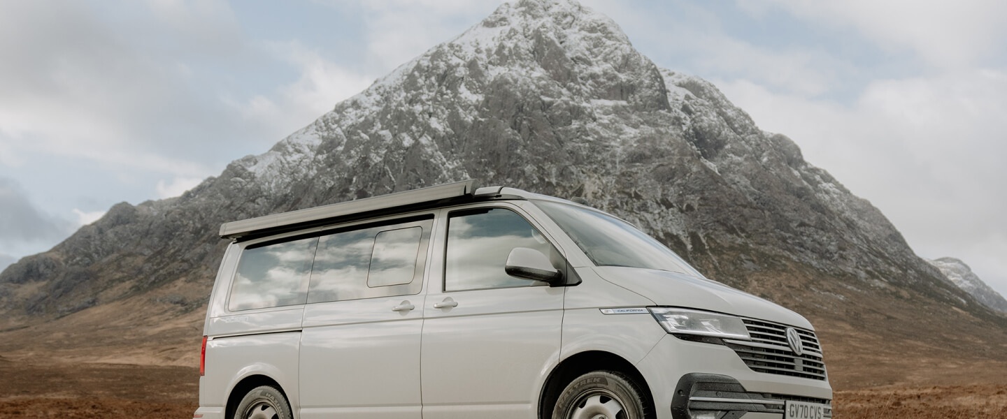 Van with snowy hills